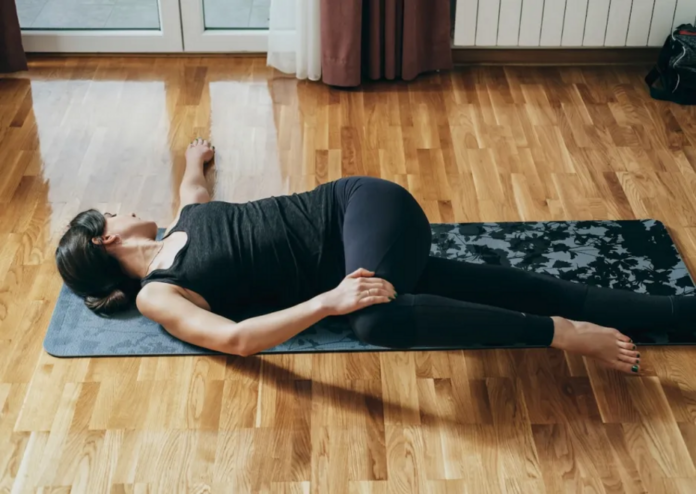 Sit all day? The open book stretch can give your stiff, sore back much-needed relief