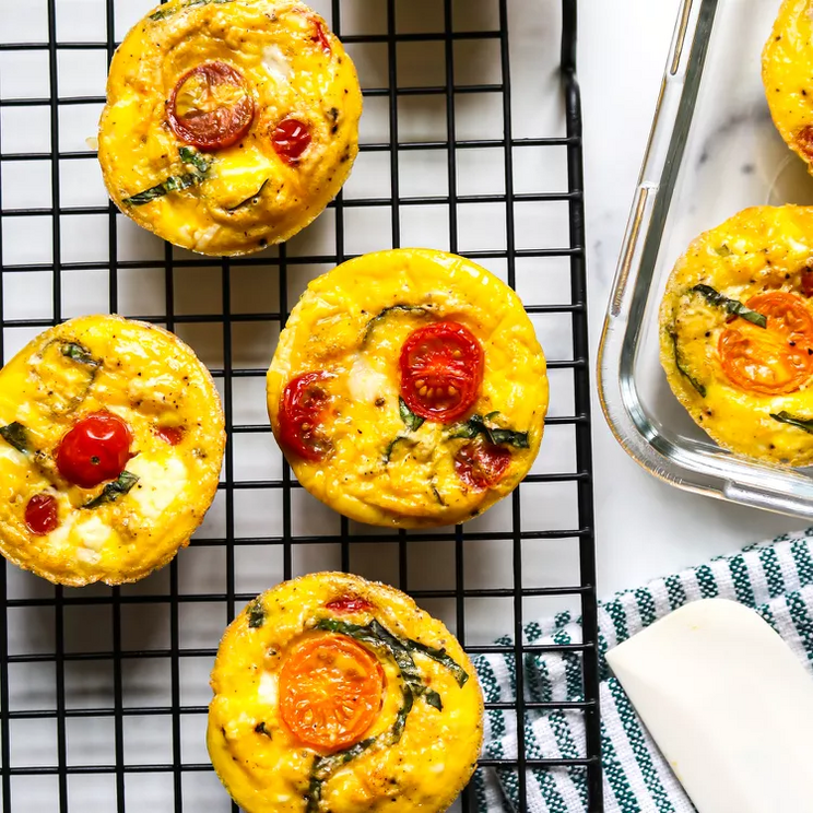 Three-ingredient baked feta and cherry tomato egg muffins